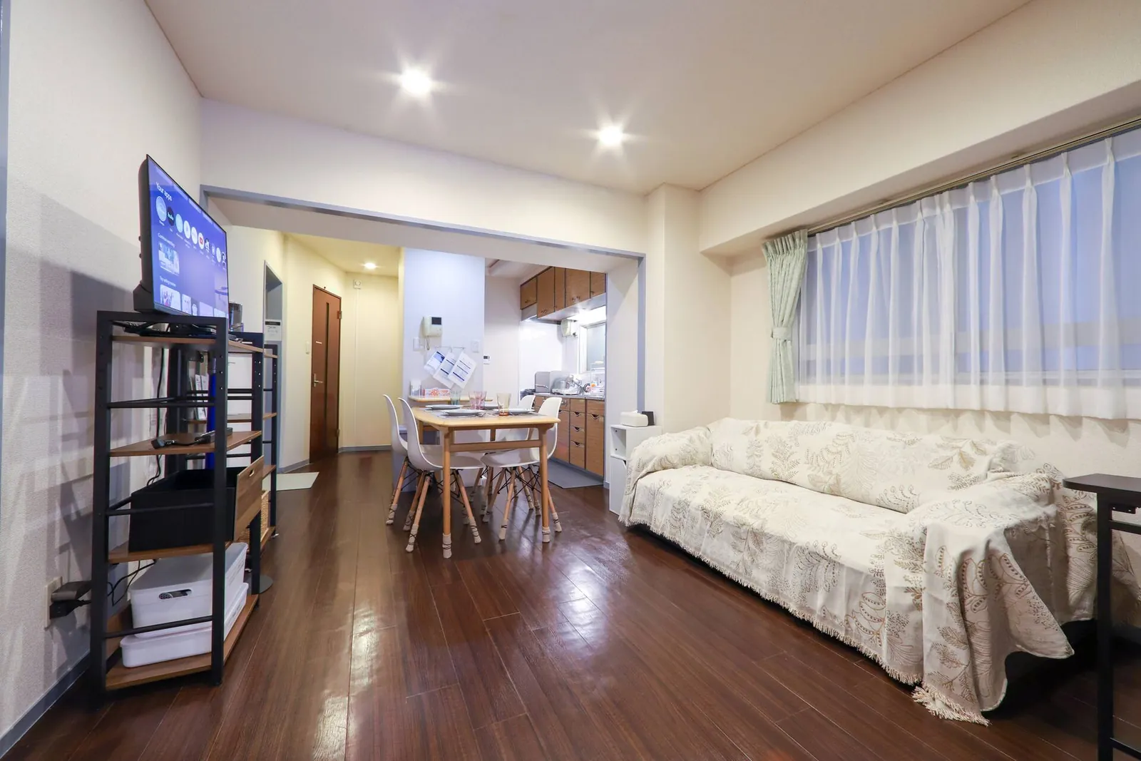 Living room at Gotanda Riverside Inn with sofa, TV and dining table